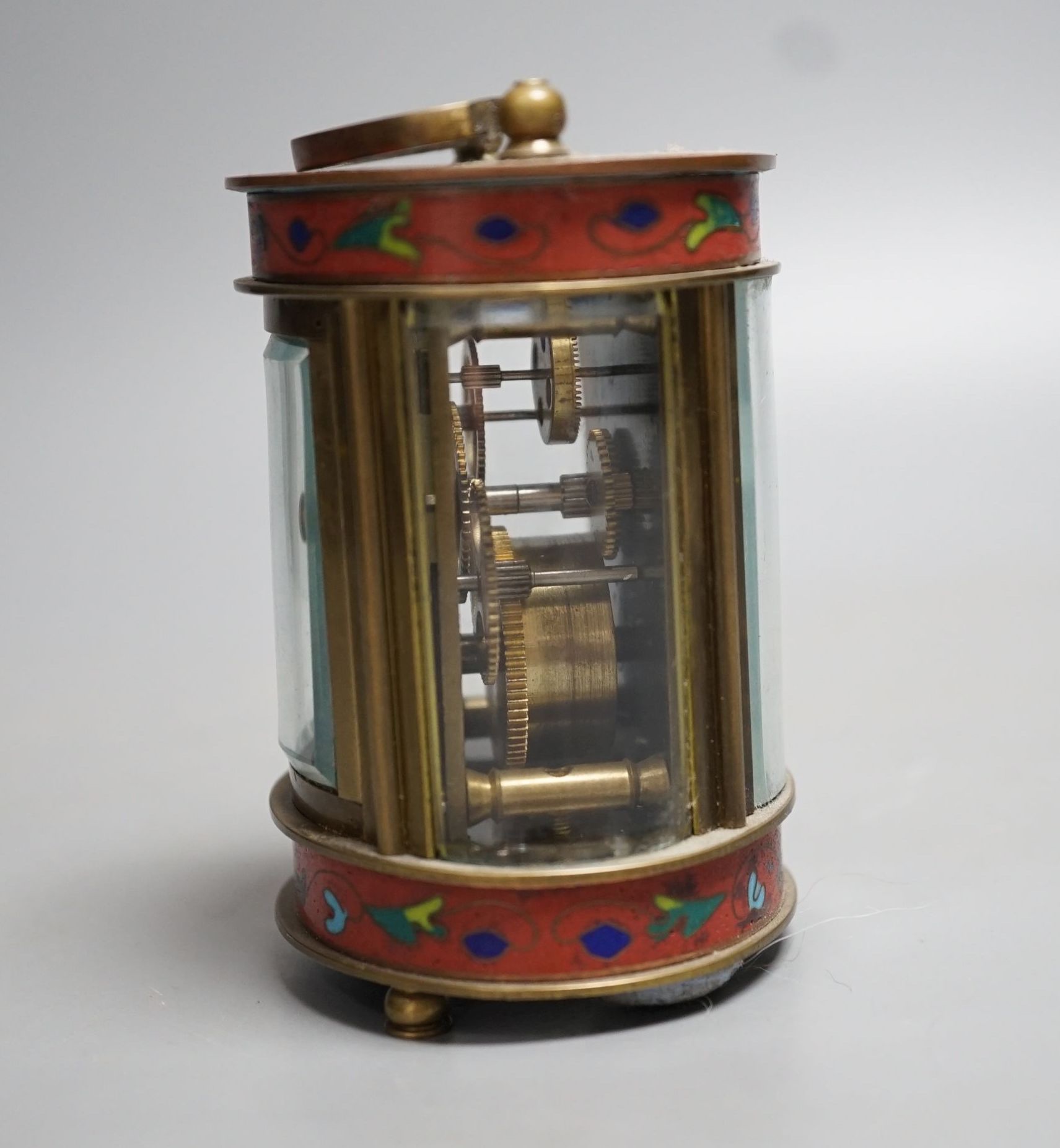 A mignonette oval brass and champleve enamelled timepiece 9cm